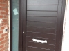 Puerta de calle PVC marrón negro panel IP7